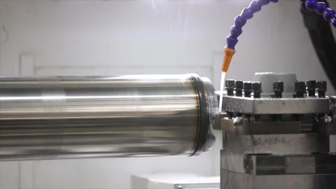 CNC Lathe Cutting Tool and Coolant System Processing a Large Steel Shaft in a Stock Footage 329454286