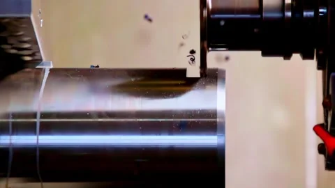 CNC lathe machine cutting metal cylinder with flying chips macro shots Stock Footage 331987844