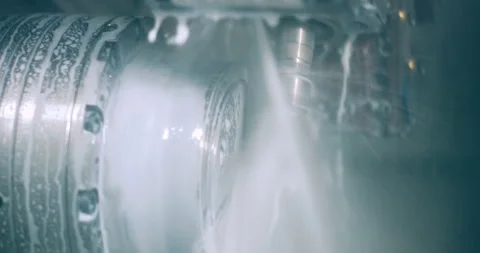 CNC lathe machine using liquid coolant while machining metal part in factory Video stock 329680610
