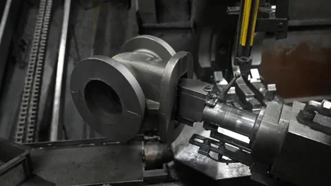 CNC lathe machining cast iron gate valve body with boring bar cutting flange Stock Footage 336631920