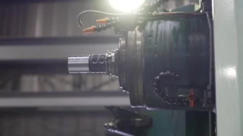 CNC lathe spindle rotating a polished steel shaft during precision turning Stock Footage 341587028