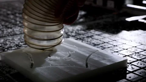 CNC machine carving plastic block with a milling tool, using vacuum for deb.. Stock Footage 317916949