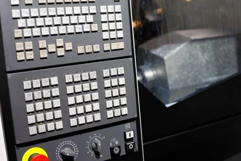 CNC machine with control panel on the foreground Stock Photos