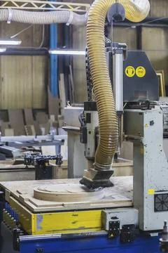 CNC machine cuts a round piece at the factory Stock Photos