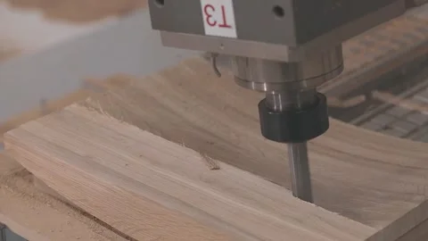CNC machine cutting and shaping wood in a furniture factory. Stockbeeldmateriaal 341626917