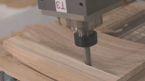 CNC machine cutting and shaping wood in a furniture factory. Smart Manufacturing Video stock 347576415