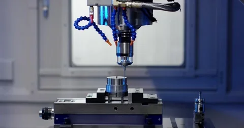 CNC Machine Drilling Metal Part with Blue Coolant, Precision Machining, Close Up Stock Footage 340654831