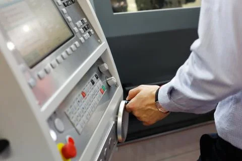 CNC machine operator making adjustments Stock Photos