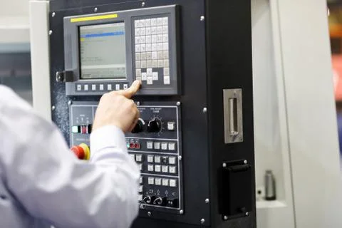 CNC machine operator working with a control panel Stock Photos