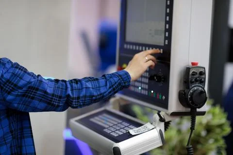 CNC machine operator working with control console Stock Photos