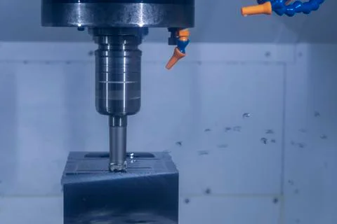 CNC machine tool cutting raw material in factory Stock Photos