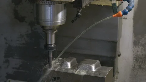 CNC Machine At Work with steel and liquid lubricant, panning, close-up shot Stock Footage 125170313