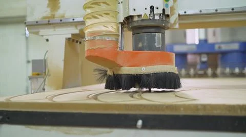 The CNC machine is working. Close-up of a numerical control machine cuts a tr Stock Photos