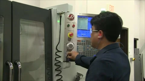 CNC machinist setting up milling machine Stock Footage 57464261