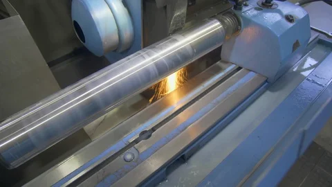 CNC metal grinding machine. Make the steel part smooth to shine. Sparks during Stock Footage 129100807