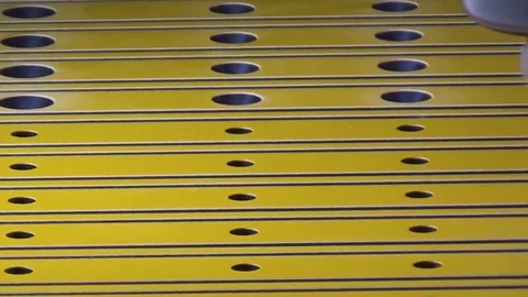 The CNC milling and engraving machine expands the holes in the plastic blank Stock Footage