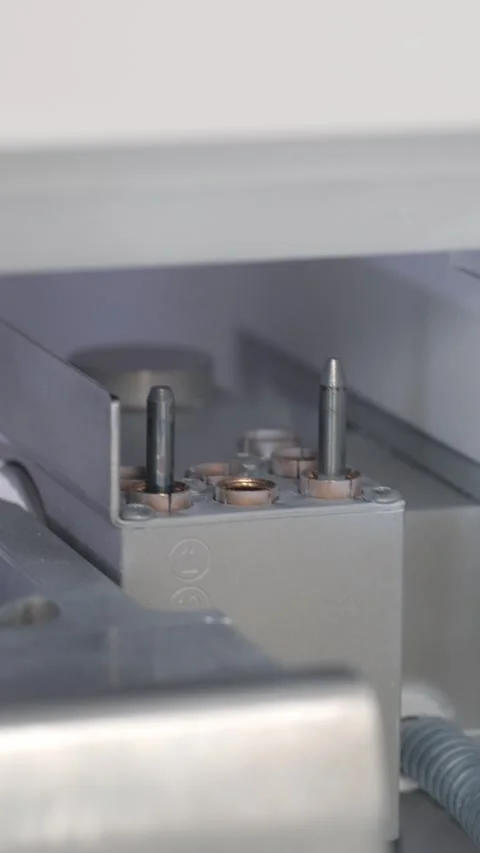 A CNC milling head approaches the drill block and selects the required diameter Stock Footage 320099822