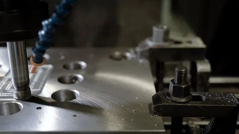 CNC milling machine in action, cutting metal piece. Stock Footage 94998494