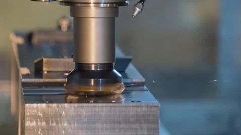 CNC milling machine in operation cutting metal in a manufacturing machine shop. Stock Footage 110955197