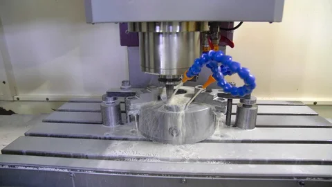 CNC milling machine in operation. Manufacturing of metal parts. Steadycam. Stock Footage 128810831