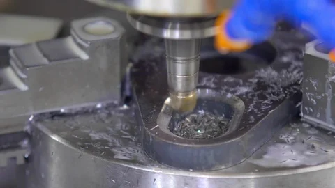 CNC milling machine in operation. Manufacturing of metal parts. Close-up Stock Footage 129844400