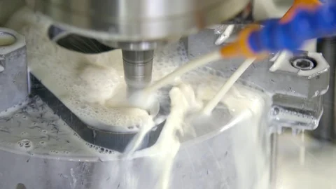 CNC milling machine in operation. Manufacturing of metal parts. Cooling of the Stock Footage 129845683
