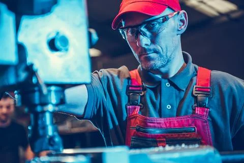 CNC Milling Machine Operator During Work Stock Photos