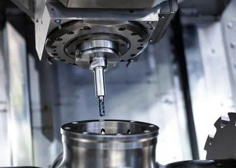 Cnc milling machine. Processing and cutting of parts from a piece of metal in Fotos Stock