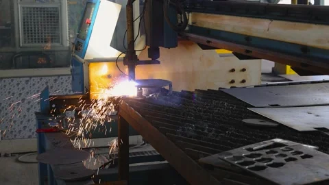 CNC operated Plasma cutting machine cutting metal sheet in a factory Stock Footage 168169231