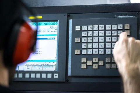 CNC operator, mechanical technician worker at metal machining milling center  Stock Photos