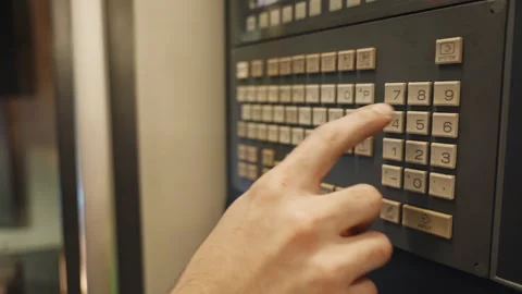 CNC Operator Pressing Control Panel on Machining Center Stock Footage 337190278