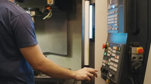 CNC Operator Pressing Control Panel on Machining Center Stock Footage 337202418