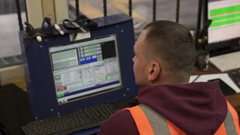 A CNC operator programs a plasma cutting machine in a workshop. Stock Footage 272449956