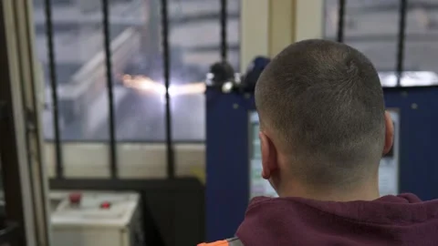 A CNC operator programs a plasma cutting machine in a workshop. An industrial wo Stock Footage 273045396
