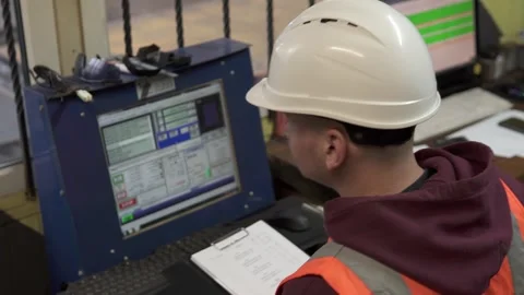 A CNC operator programs a plasma cutting machine in a workshop. Stock Footage 273045528