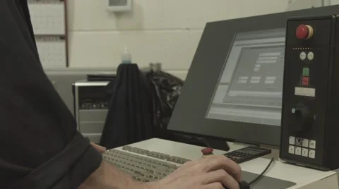 CNC Operator Uses Old Computer Terminal to Program CNC Machine Stock Footage 62926701