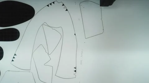 CNC plotter machine drawing shoe pattern templates on white paper Stock Footage 333014917