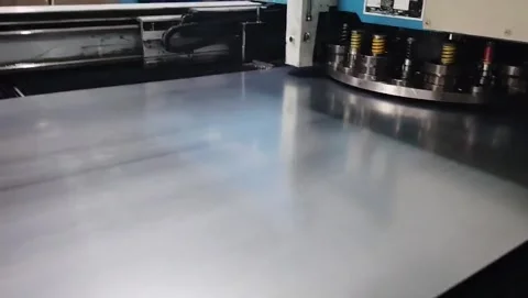 CNC punch press machine processing sheet metal surface. Stock Footage 335874025