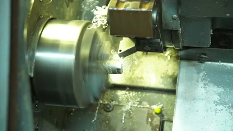 Cnc silver bar cutting lathe. silver ring production. industrial precision cut Stock Footage 139610372