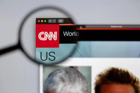 CNN channel logo visible  through a magnifying glass. Stock Photos