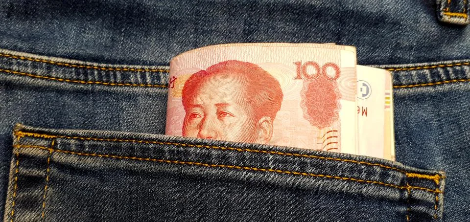 CNY. A stack of paper bills in the back pocket of jeans. Chinese money Stock Photos