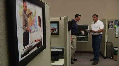 Co-workers discuss at cubicle Stock Footage 8608097