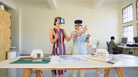 Co-workers with floor plans layouts in architecture firm Video stock 73312984