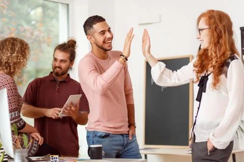 Co-workers giving a high five Stock Photos