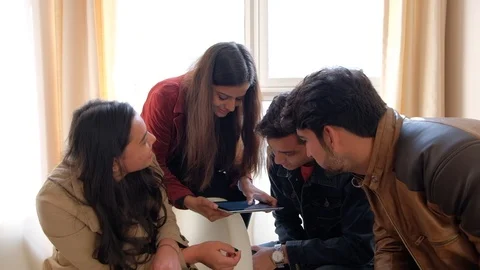 Co workers looking intently at a screen with purpose and dedication and share  Video stock 101226283