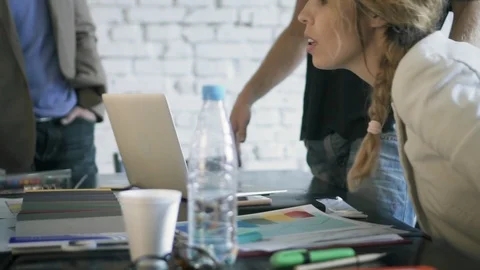 Co-workers in the office are discussing something during coffee break Stock Footage 90491691