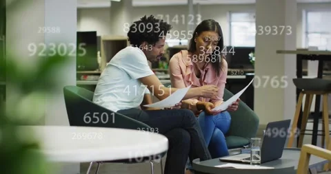 Co-workers reviewing reports and discussing figures for financial analysis, Stock Footage 317154145