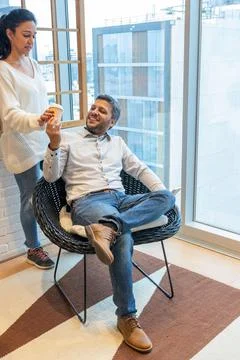 Co-workers sharing a container of coffee Stock Photos