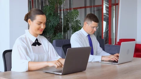 Co workers sitting at the workplace in modern office Stock Footage 118241174