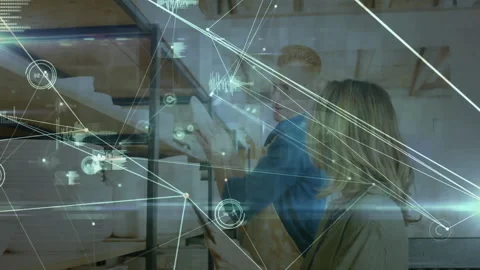Co-workers tapping tablet while lifting plate in store, comparing specs with Stock Footage 309683414